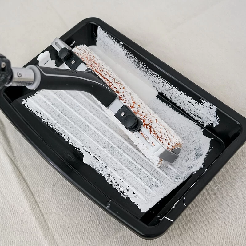 Loading a paint roller evenly on a ridged paint tray